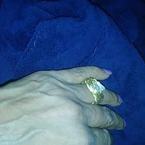 A gold colored wire ring with crystal setting